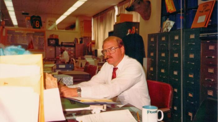 The Wonderland Massacre TV show screenshot 2: Rick Jackson sits at his desk in an archive photo. 
