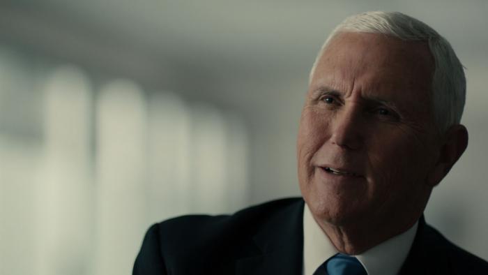 The American Experiment TV show screenshot: Mike Pence in a suit with a serious expression indoors.
