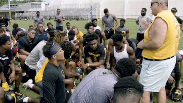 The Cost of Winning TV Show: Coach Poggi talks to students during practice