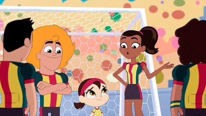 Underdogs United TV show screenshot 2: The team stands around Gigi in front of the goal during a soccer match.
