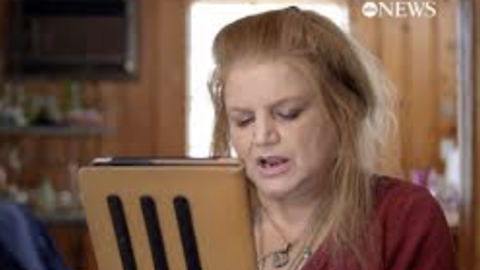 Web of Death: Online sleuth Tricia Griffiths looks at a tablet and discusses evidence.