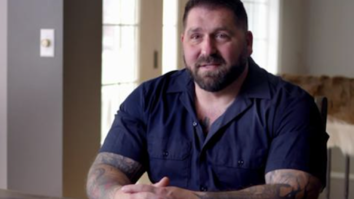 Web of Death: Bob Ruff sits at a table and discusses his work.