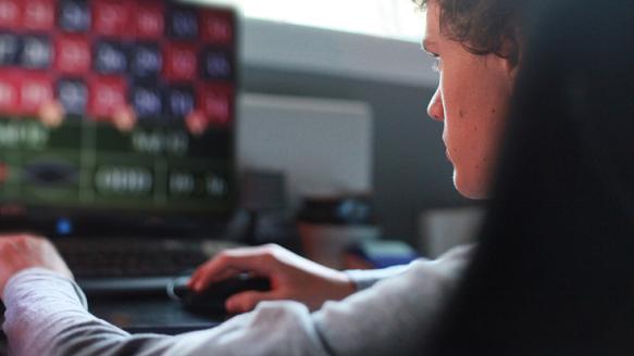 Boy betting on a computer