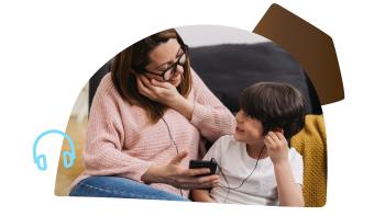 woman and child listening to device with headphones together