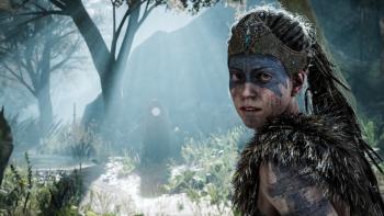 Senua's Saga—Hellblade II screenshot: Senua in a forest with face paint on around her eyes