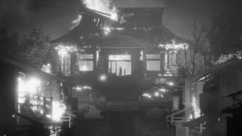 Hiroki stands in the entrance to his burning dojo, looking over his village in flames.