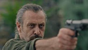 10 Days of a Curious Man Movie: A man points a gun