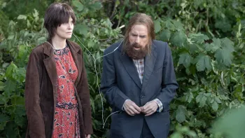 Bolan's Shoes: A woman and a bearded man share some headphones