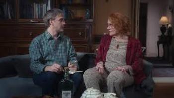 27 Nights Movie: Older woman sits with bespectacled man