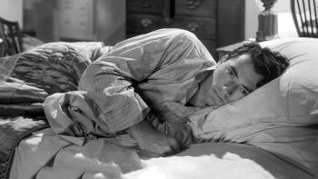 Gentleman's Agreement: Gregory Peck lying on his side in bed