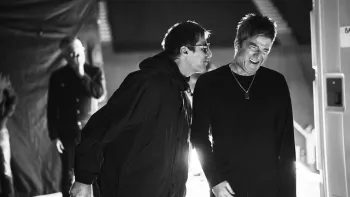 Oasis—Don't Look Back in Anger: Liam and Noel Gallagher in mid-conversation, black and white photograph, with a bright light behind them