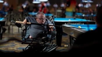 96 Pounds of Dynamite movie: Chad holds a cue stick as he shoots pool at a pool table