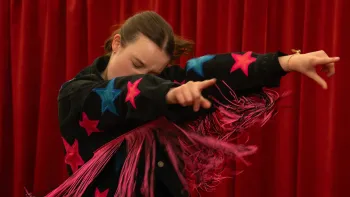 Sunny Dancer: Teen girl in a black jacket with pink stars and fringe, posing dynamically