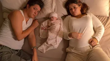 A Child of My Own: Couple in bed with baby.