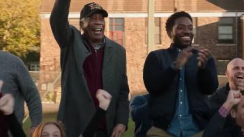 A Good Person Movie: Morgan Freeman stands and cheers in the stands next to his adult son (Chinaza Uche)