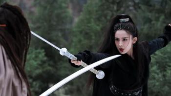 A Legend: A woman and a man sword fighting in a forest