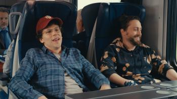 A Real Pain movie: Jesse Eisenberg laughs with Kieran Culkin on a train
