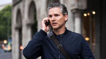 A Sacrifice: Eric Bana stands outside a building looking worried as he talks into a phone