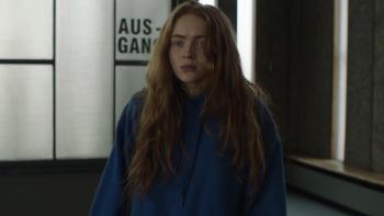 A Sacrifice: Sadie Sink looks upset, wearing a blue sweatshirt at an airport