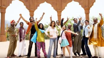 Aaja Nachle: A cheerful group of Indian people of various ages and styles pose outdoors, raising their arms and smiling energetically