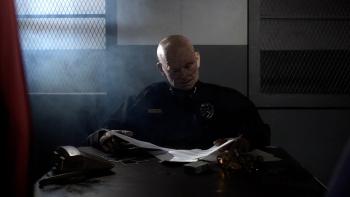 Abruptio Movie: Police Chief Richter (voiced by Christopher McDonald) sits behind his desk