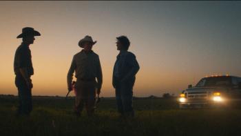 Accidental Texan Movie: Three cowboys stand in a field at dusk