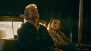 Acidman Movie: Thomas Haden Church and Dianna Agron hopefully watch the skies while sitting in the bed of a pickup truck.