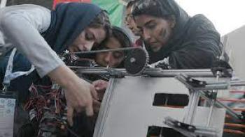 Afghan Dreamers: Three Afghan teenage girls work over their robot