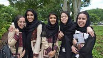 Afghan Dreamers: Five Afghan teenage girls pose for a picture in a park with trees behind them