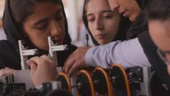 Afghan Dreamers: Afghan teenage girls work over their robot in close-up