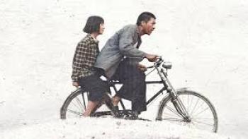A Foggy Tale: Man cycling with girl sitting on bike's rear, against light background.