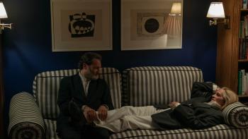 After the Hunt movie: Frederik (Michael Stuhlbarg) rubs the feet of his wife, Alma (Julia Roberts), while she lies on a striped couch