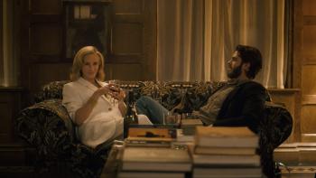 After the Hunt movie: Alma (Julia Roberts) and Hank (Andrew Garfield) sit together on a couch at a dinner party, drinking wine