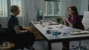 After the Wedding Movie: Isabel sits in front of Theresa, who's behind a desk in an office