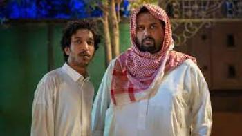 AlKhallat+: two men are dressed in traditional Saudi outfits, both in thawbs and on in a kufiyyahdre