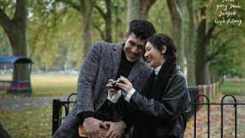 A Long Way to Come Home Scene 3: A woman and man cuddle on a park bench