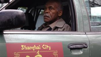 American Dreamer Movie: Danny Glover sits in a car