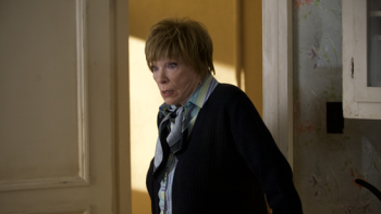 American Dreamer Movie: Shirley MacLaine stands in a doorway