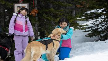 American Girl: Corinne Tan: Kai and Maya Cech with a dog in the mountains.