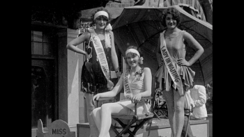 Still from American Royalty: Three Miss America Pageant contestants, wearing sashes over swimsuits during the early 20th century