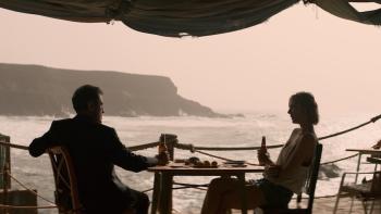 American Star Movie: Wilson (Ian McShane, left) has lunch with Gloria (Nora Arnezeder) at a seaside restaurant