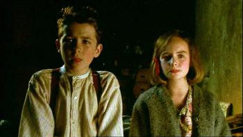 An Angel for May: Tom and May stand together inside a living room