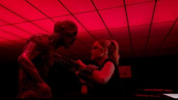 Angels Fallen -- Warriors of Peace: Denise Richards stabs a demon in the chest with a sword with a pink light above