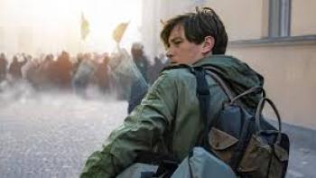 An Honest Life: Young man with backpack looks over his shoulder