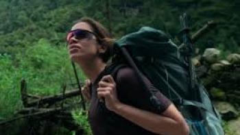 Larissa: The Other Side of Anitta: A woman backpacks in a forest