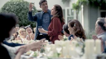 Anniversary movie: Diane Lane and Kyle Chandler toast affectionately amid their guests at an outdoor party