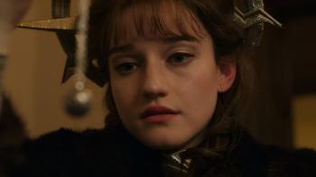 Apartment 7A movie: Julia Garner center stares at a sphere pendant on a necklace in the left foreground