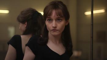 Apartment 7A movie: Julia Garner in leotard leans her back against a wall mirror