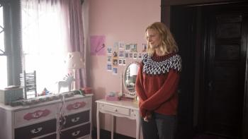 The Apology Movie: Wearing a festive holiday sweater, Darlene (Anna Gunn) stands in what appears to be a child's bedroom