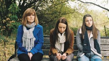 Apostasy: Siobhan Finneran, Sacha Parkinson, and Molly Wright sit on a park bench together looking troubled